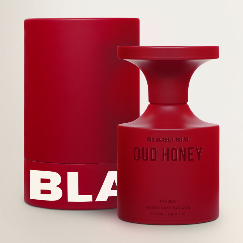 Red perfume bottle and packaging with 'BLA' branding on a light beige background